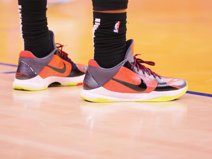 View of orange and black Nike Kobe shoes.